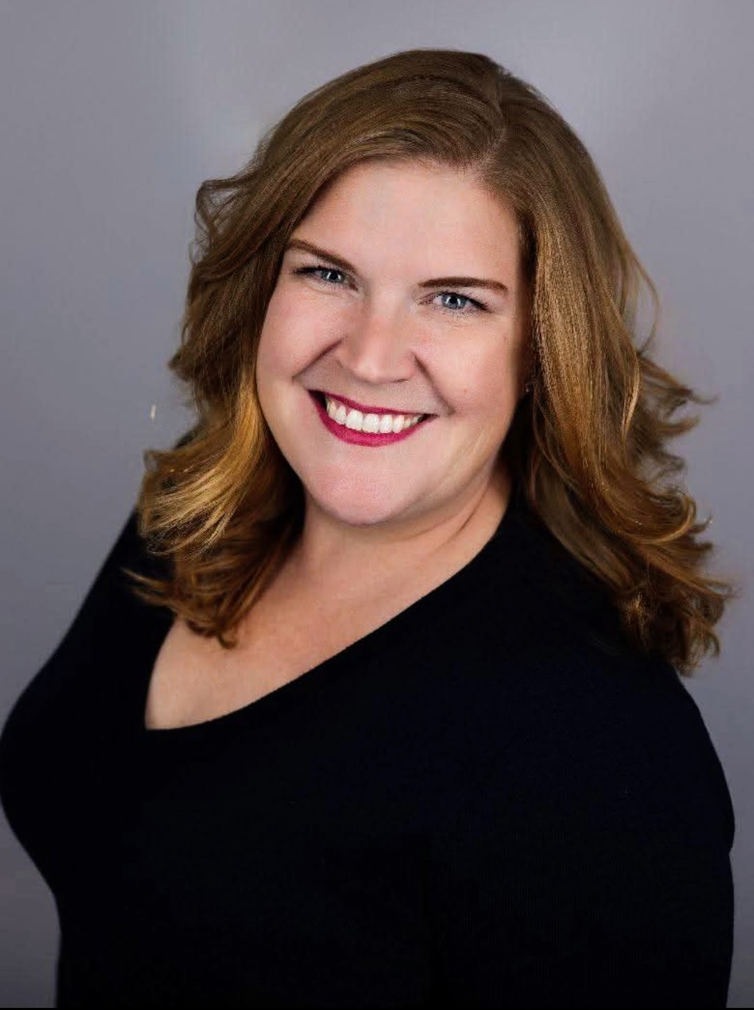 jana powell happily standing in her clinic